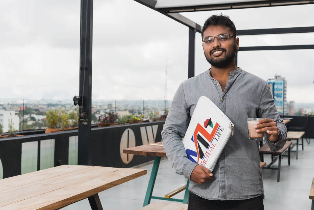 laptop sleeve mockup of a man holding a computer on a terrace 30863